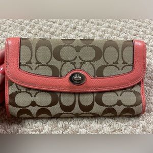 Pre owned signature brown with coral trim Coach wallet